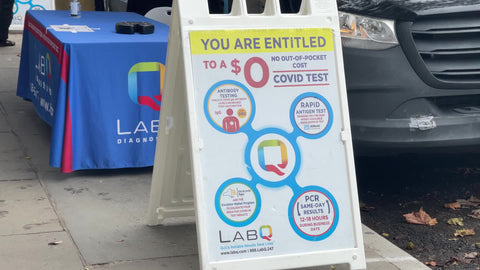 you are entitled to free Covid testing sign on street medical van testing people New York City