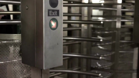 faceless man entering subway station revolving turnstile in slow motion