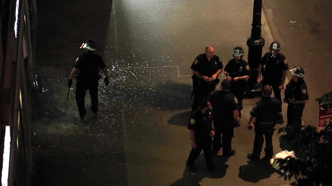police officers show up to scene of vandalism and broken glass at storefront at night in NYC