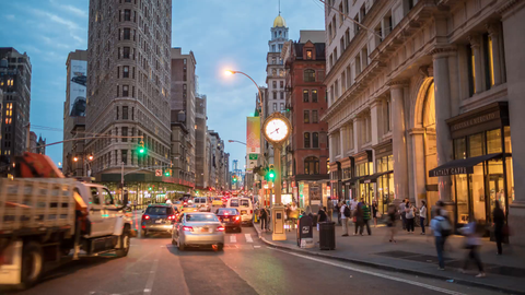 5th Avenue clock in evening timelapse - cars speeding in Manhattan traffic - in 4K and 1080 HD in NYC