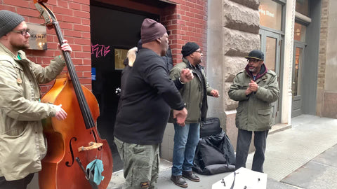 Doo Wop group singing on public street for people walking by in New York City NYC