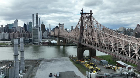 aerial close Queensboro Bridge over East River water toward Manhattan New York City