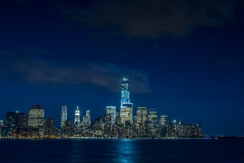 Downtown Manhattan skyline at night with Freedom Tower and skyscrapers - from East River view