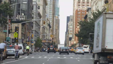 driver pov on summer day - man on bicycle on 6th Avenue