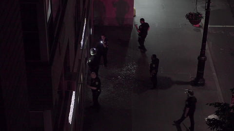 cops investigating crime scene with broken glass in New York City