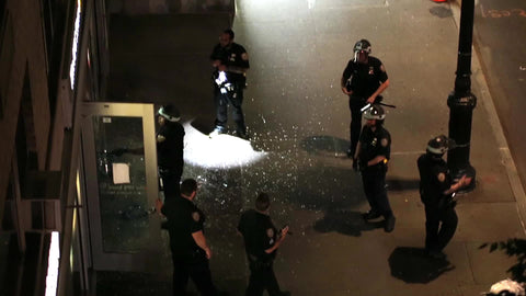 police investigating broken window at storefront scene of crime in New York City