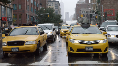 taxi cabs driving in rain with windshield wipers - 4K slow motion on 6th Ave in Manhattan NYC