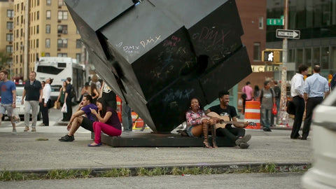Cooper Square with hippies playing guitar - couple in love - famous cube sculpture in 1080 HD in NYC