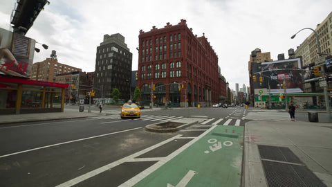 taxi cab turning corner at Houston and Lafayette street on quiet morning in NYC