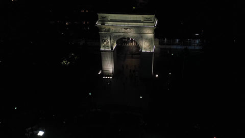 pushing toward 5th Ave and Empire State Building over Washington Square Park arch Manhattan New York City NYC night