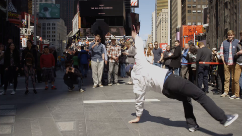 breakdancer doing swipes in Times Square before a crowd - 4K in slow motion NYC