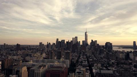 late moving aerial shot pulling backwards from Freedom Tower over Manhattan New York City NYC