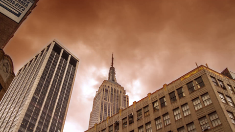red fiery sky over Empire State Building towering in Manhattan - 4K timelapse with clouds in NYC