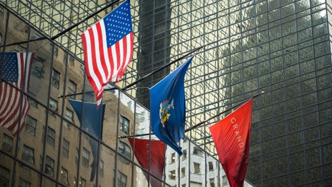 3 flags on corporate office building - American flag in Midtown Manhattan during day