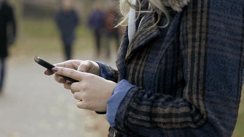 woman using smartphone - texting on phone - close up