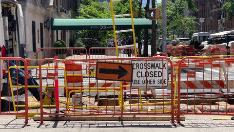 crosswalk closed construction site orange arrow sign Manhattan sunny day New York City NYC