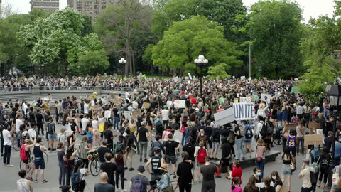 unite sign at protest in Washington Square Park