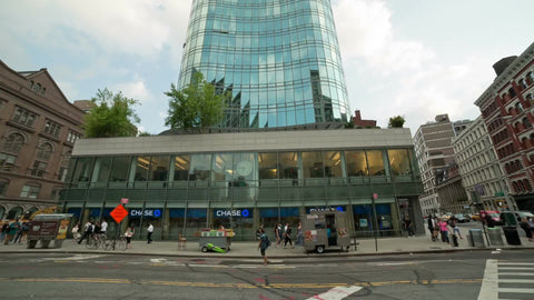 Chase Bank in Cooper Square on summer day with people walking on sidewalk in Manhattan NYC