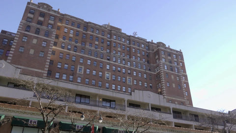 B&H Photo Superstore Establishing shot tilting down onto 9th Ave traffic outside in New York City NYC