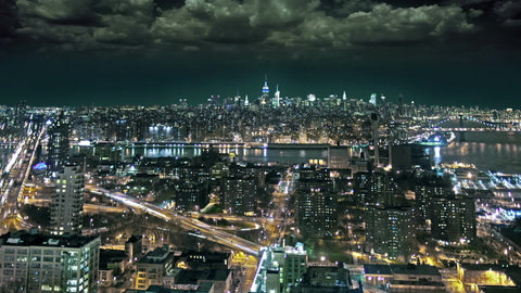 timelapse of traffic moving in Brooklyn with scary weather coming storm clouds in sky at night Manhattan New York City NYC