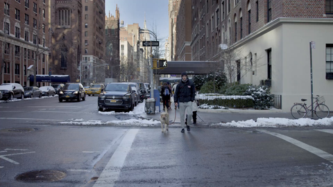 man walking dog on Lower 5th Ave with snow on street - cold winter day in Manhattan - 4K NYC