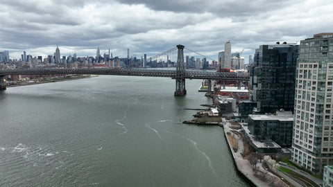 aerial moving toward Williamsburg Bridge on East River in New York City