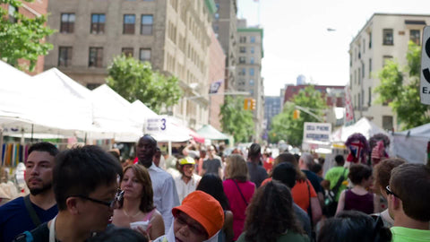 street fair in Greenwich Village on summer day - people crowded on University Place in NYC
