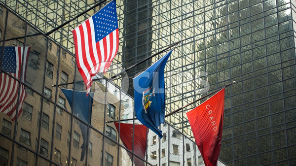 3 flags on corporate office building - American flag in Midtown Manhattan during day