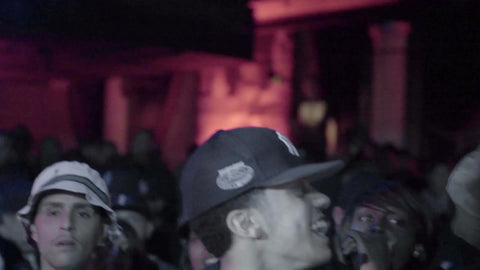 rap fans having fun in audience - man in crowd with Yankee hat enjoying hip hop show