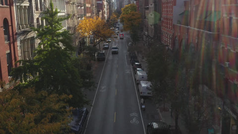 aerial cars driving down colorful street in SoHo fall trees New York City NYC