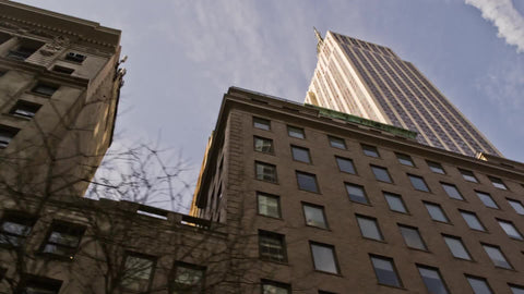 upward angle of Empire State Building towering over Manhattan from moving vehicle in NYC