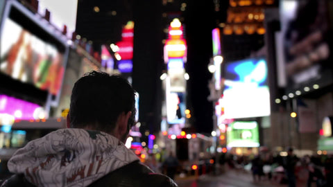 tourist taking photo in Times Square New York City at night NYC