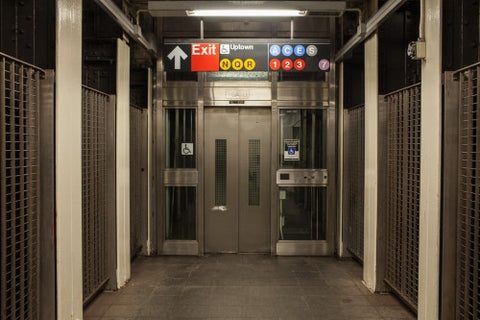 subway station elevator at Times Square with all lines on sign