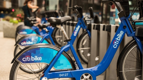 Citi Bikes parked at docking station in Manhattan on sunny summer day