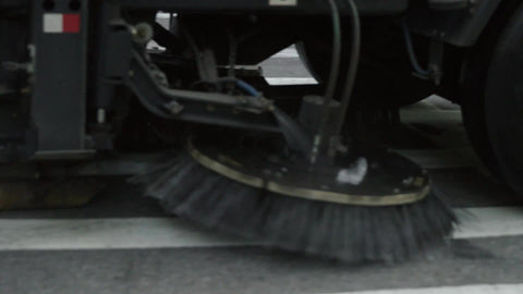 street sweeper driving close up slow motion brushes spinning Manhattan NYC
