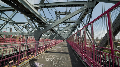 Williamsburg Bridge interior, panning inside steel bars on summer day in NYC