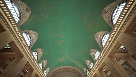 tilting down to crowded Grand Central Station Terminal main room in summer NYC