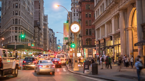 cars zooming past 5th Avenue clock at night - Manhattan traffic time-lase in 4K and 1080 HD in NYC