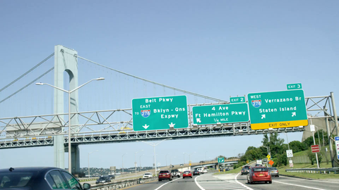 driving under sign for Staten Island with Verrazano Bridge from driver POV - 4K highway in NYC