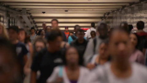 people walking in slow motion in subway tunnel corridor in summer in NYC