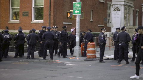 group of NYPD police officers congregated on corner in street University Place in the Village NYC