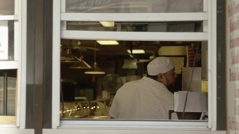 pizza and pasta window storefront with cook in window - chef in deli restaurant