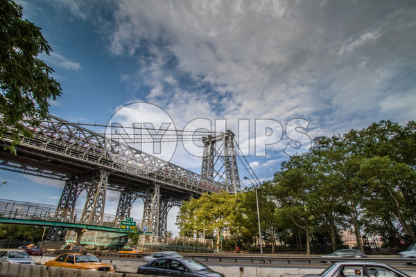 Williamsburg Bridge with Houston Street exit sign in Manhattan with cars driving on FDR Drive highway on bright sunny day