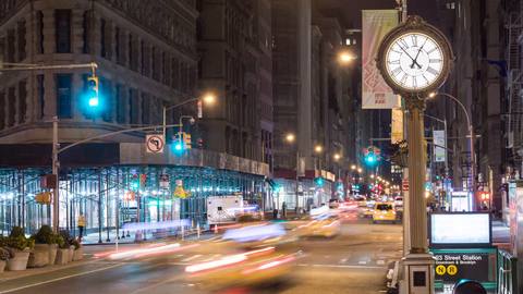 N and R subway train station with 5th Ave clock and cars speeding in timelapse of street at night in 4K and 1080 HD in NYC