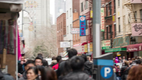 poppers going off and confetti falling to ground on Chinese New Year celebration in Chinatown