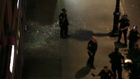 NYPD police officers smoking cigarette at crime scene at night New York City