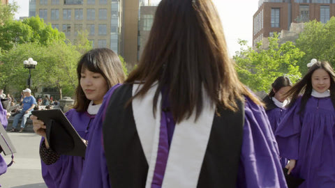 young women in purple NYU cap and gown - graduates in Washington Square Park - Asian girls graduating college in NYC
