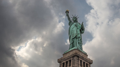 Statue of Liberty on base in HDR - 4K upward angle timelapse - full length shot in New York City