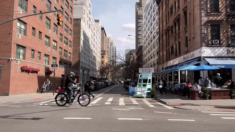 Beach Cafe restaurant on corner outdoor seating tables outside dining covid pandemic blue umbrellas Manhattan New York City NYC