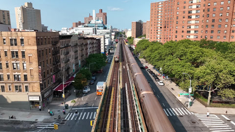 two 1 trains crossing paths on elevated subway track in Harlem New York City NYC